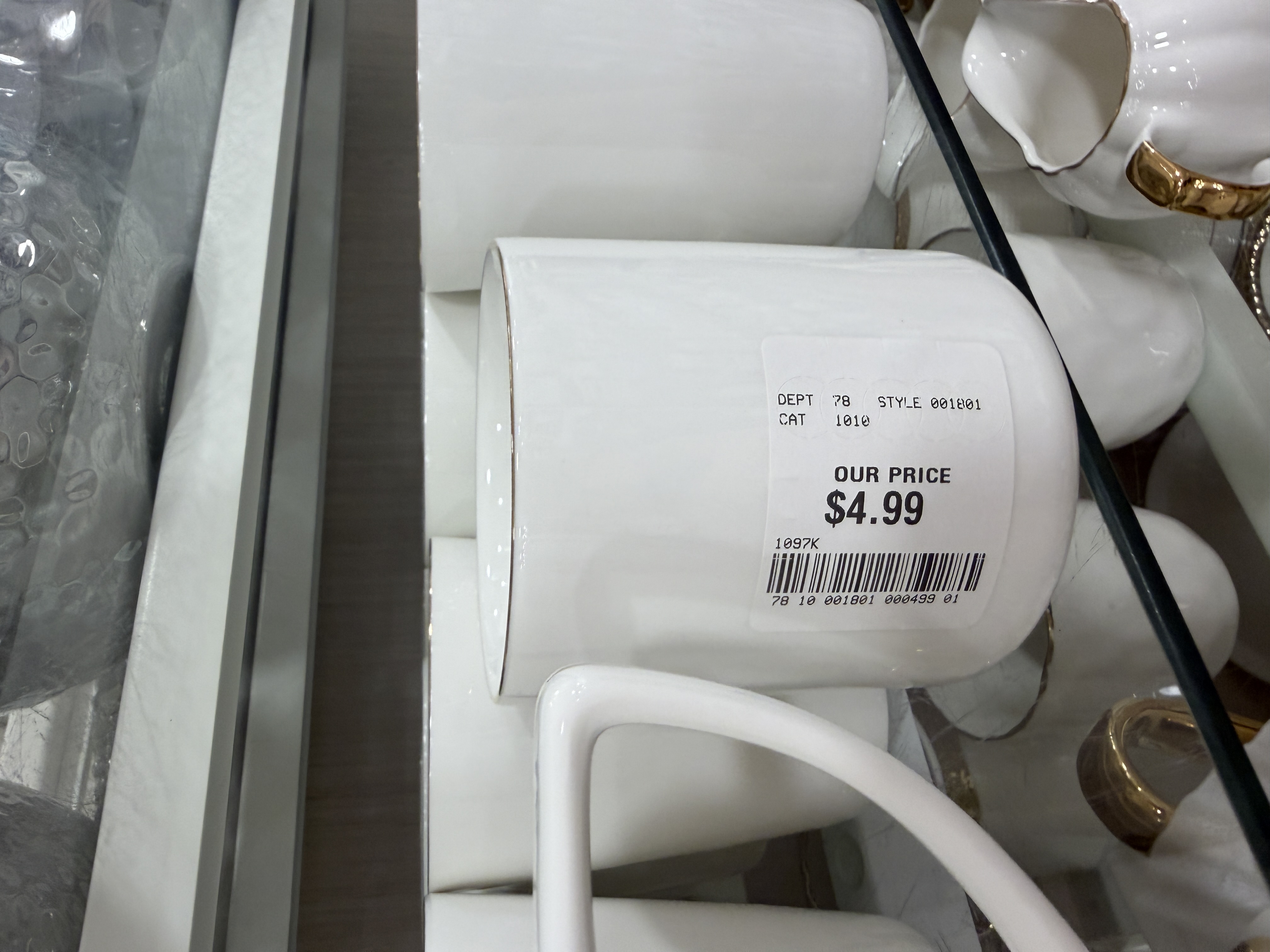 A white ceramic mug with a discount price sticker